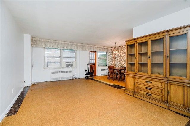 1935 Shore Pkwy Unit 8E, Brooklyn, NY 11214 - living room featuring radiator heating unit and a chandelier