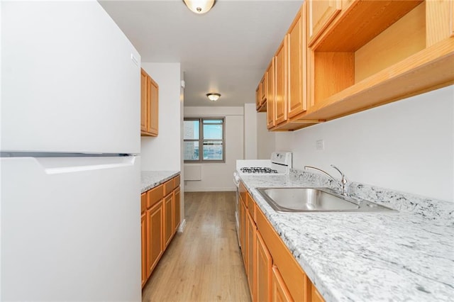 444 Neptune Ave Unit 2S, Brooklyn, NY 11224 - kitchen with white appliances, light wood-type flooring, and light stone countertops