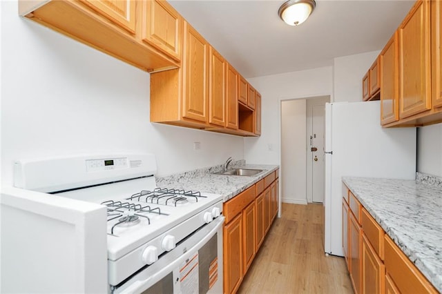 444 Neptune Ave Unit 2S, Brooklyn, NY 11224 - kitchen featuring white appliances, light wood finished floors, and light stone counters
