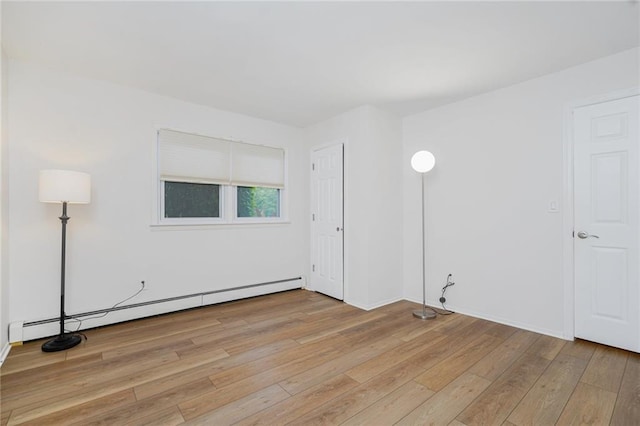 444 Neptune Ave Unit 2S, Brooklyn, NY 11224 - empty room with baseboard heating and light wood-style flooring
