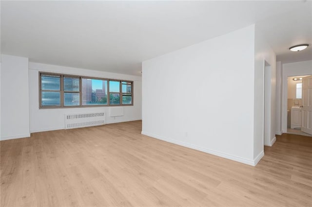 444 Neptune Ave Unit 2S, Brooklyn, NY 11224 - empty room featuring radiator heating unit and light wood-type flooring