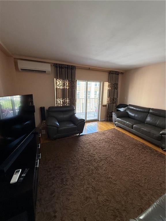 2964 Brighton 6th St Unit 4B, Brooklyn, NY 11235 - living area featuring an AC wall unit and wood finished floors