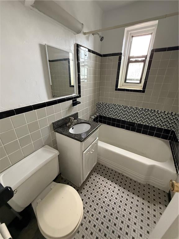 2821 Kings Hwy Unit 4M, Brooklyn, NY 11229 - bathroom featuring tile walls, vanity, shower / tub combination, and a wainscoted wall