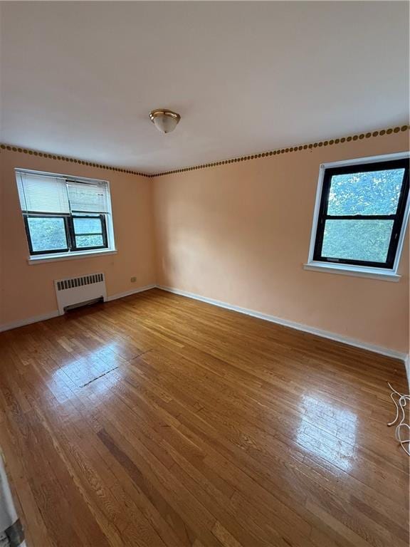 2821 Kings Hwy Unit 4M, Brooklyn, NY 11229 - empty room with radiator and wood finished floors