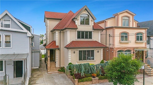 1650 68th St, Brooklyn, NY 11204 - view of front facade with a tiled roof and stucco siding