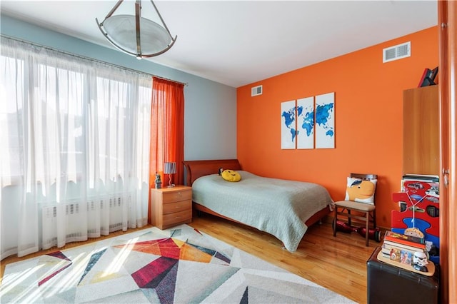 1650 68th St, Brooklyn, NY 11204 - bedroom featuring wood finished floors and radiator heating unit