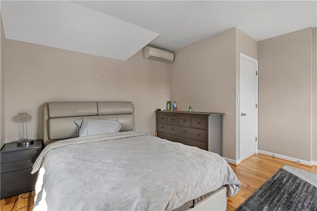 1650 68th St, Brooklyn, NY 11204 - bedroom featuring an AC wall unit and light wood-style floors