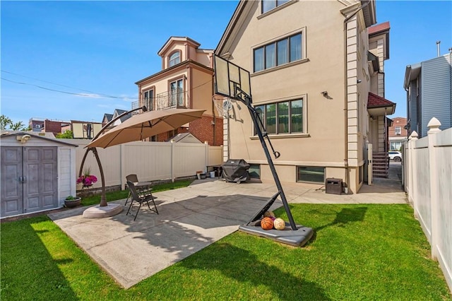 1650 68th St, Brooklyn, NY 11204 - back of property with a storage shed, stucco siding, a fenced backyard, and a patio area