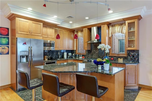 1650 68th St, Brooklyn, NY 11204 - kitchen with wall chimney range hood, stainless steel appliances, light wood finished floors, a kitchen island, and a breakfast bar area