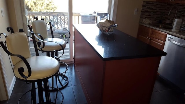 5463 Arthur Kill Rd, Staten Island, NY 10307 - kitchen with dishwasher, decorative backsplash, dark tile patterned flooring, and dark countertops