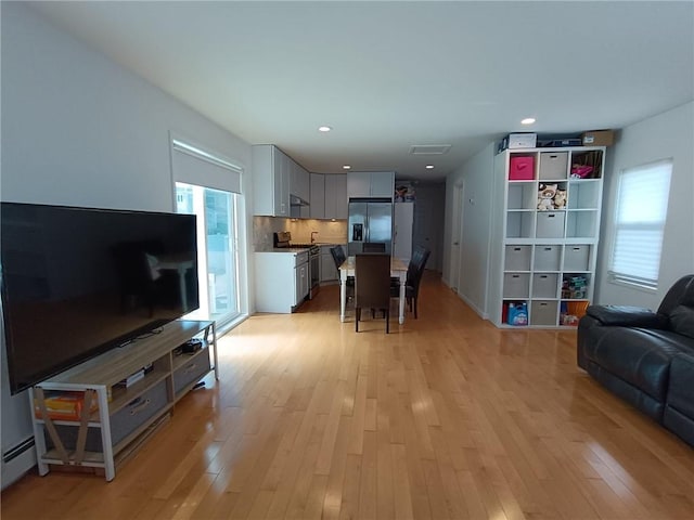 268 Nelson Ave, Staten Island, NY 10308 - living area with light wood-type flooring, recessed lighting, and a baseboard radiator