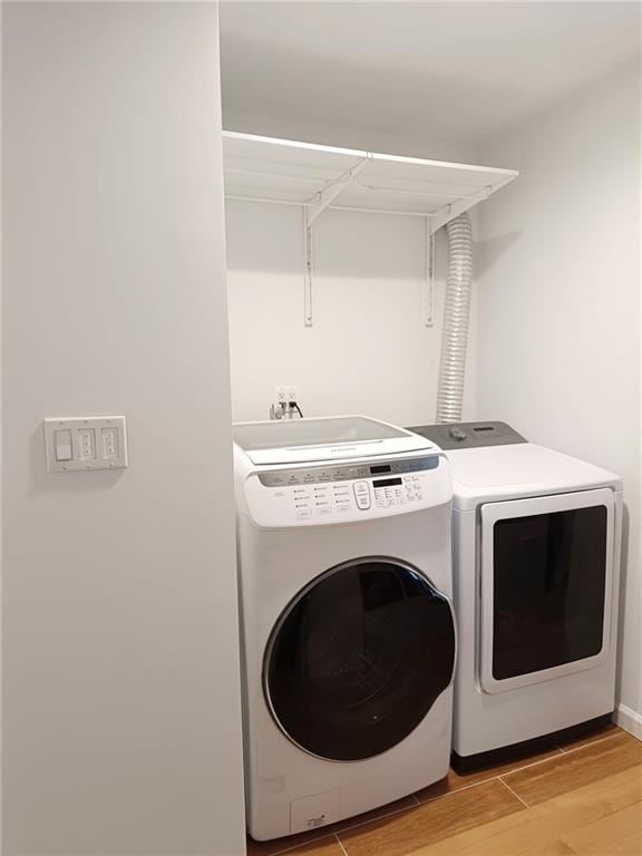 268 Nelson Ave, Staten Island, NY 10308 - laundry area with washer and clothes dryer and light wood-style flooring