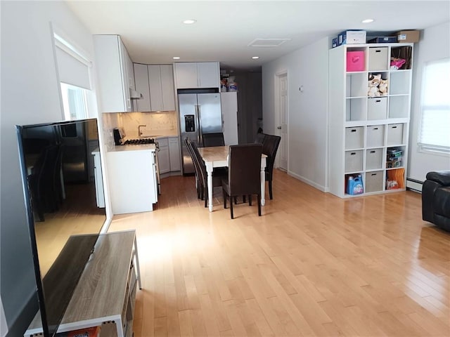 268 Nelson Ave, Staten Island, NY 10308 - kitchen featuring appliances with stainless steel finishes, light wood-style flooring, light countertops, backsplash, and recessed lighting
