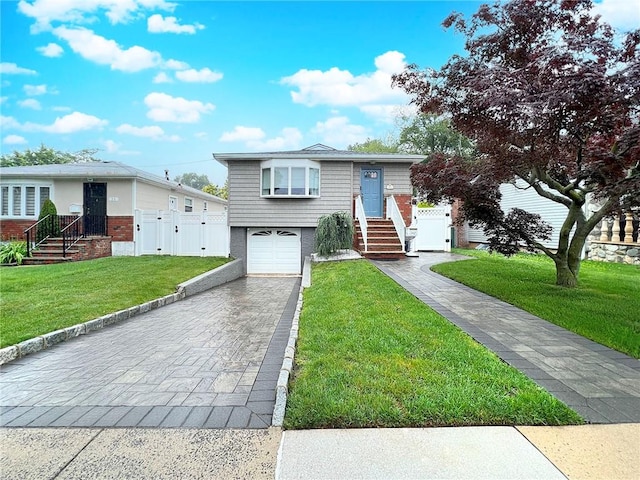 21 Stroud Ave, Staten Island, NY 10312 - view of front facade featuring brick siding, decorative driveway, a gate, and an attached garage