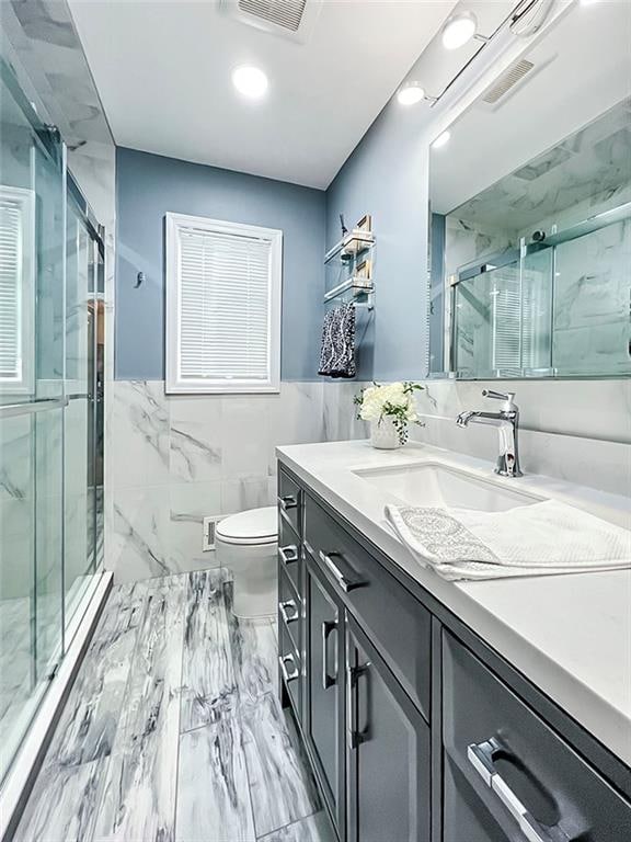 21 Stroud Ave, Staten Island, NY 10312 - bathroom with vanity, tile walls, marble finish flooring, a marble finish shower, and recessed lighting