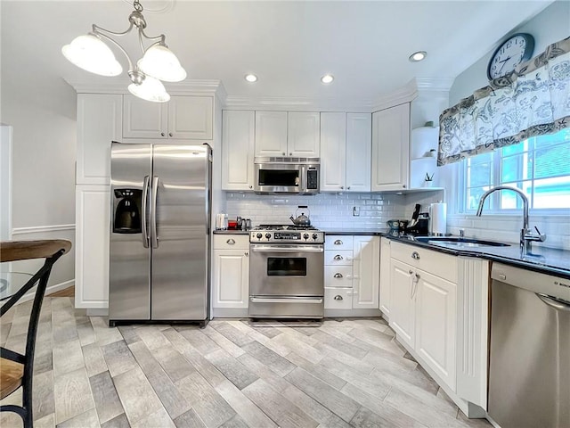 21 Stroud Ave, Staten Island, NY 10312 - kitchen with appliances with stainless steel finishes, dark countertops, decorative backsplash, white cabinetry, and recessed lighting