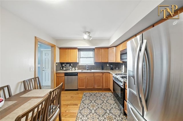 7 Kunath Ave, Staten Island, NY 10309 - kitchen featuring stainless steel appliances, backsplash, light wood finished floors, and light countertops