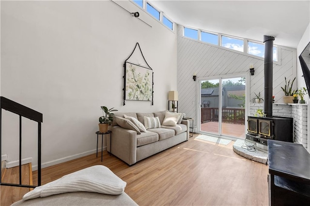 324 Norway Ave, Staten Island, NY 10305 - living area featuring a wood stove, a towering ceiling, and wood finished floors