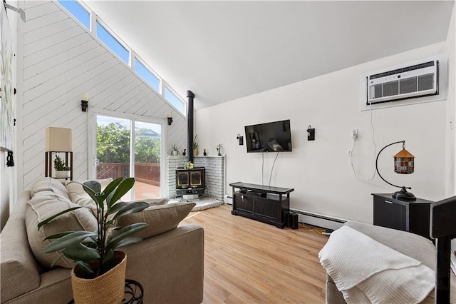 324 Norway Ave, Staten Island, NY 10305 - living area featuring a wood stove, a baseboard radiator, light wood finished floors, an AC wall unit, and high vaulted ceiling