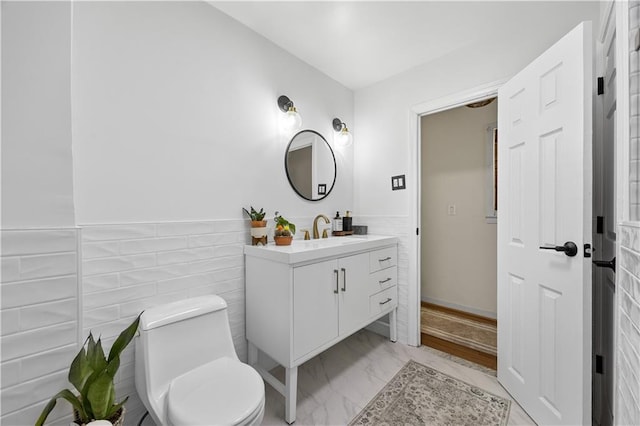 324 Norway Ave, Staten Island, NY 10305 - bathroom featuring vanity, marble look tiles, a wainscoted wall, and tile walls
