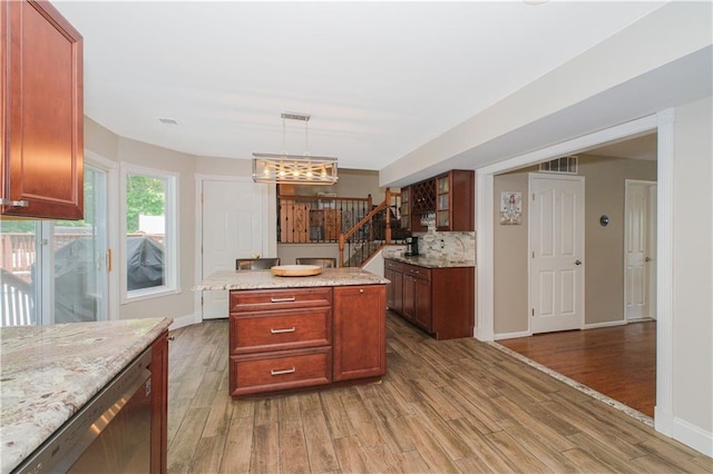 37 Quail Ln, Staten Island, NY 10309 - kitchen with light wood finished floors, stainless steel dishwasher, light stone countertops, hanging light fixtures, and a center island