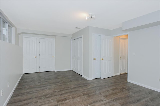 37 Quail Ln, Staten Island, NY 10309 - unfurnished bedroom featuring wood finished floors and two closets