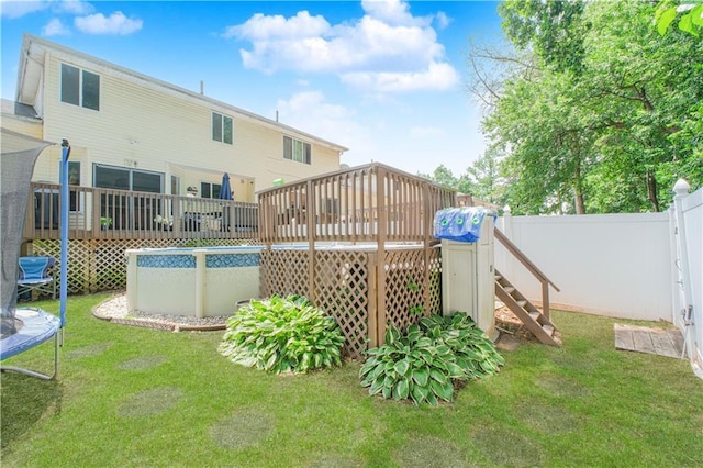 37 Quail Ln, Staten Island, NY 10309 - rear view of house featuring a trampoline, a deck, a fenced backyard, and an outdoor pool