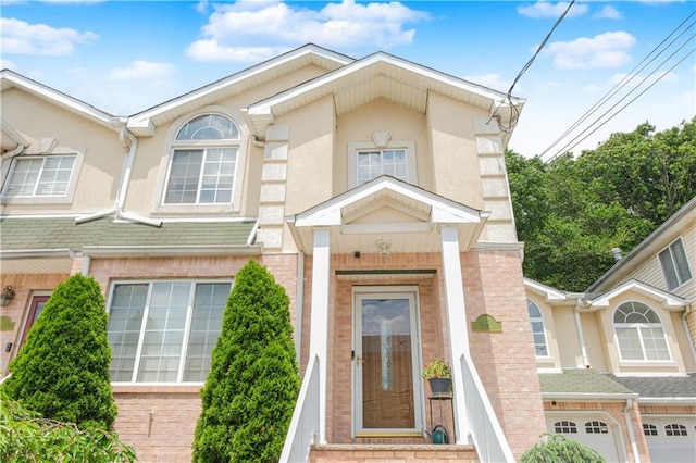 37 Quail Ln, Staten Island, NY 10309 - property entrance featuring stucco siding, brick siding, and an attached garage