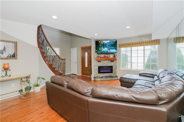 37 Quail Ln, Staten Island, NY 10309 - living room featuring light wood-style flooring, a stone fireplace, recessed lighting, and stairs