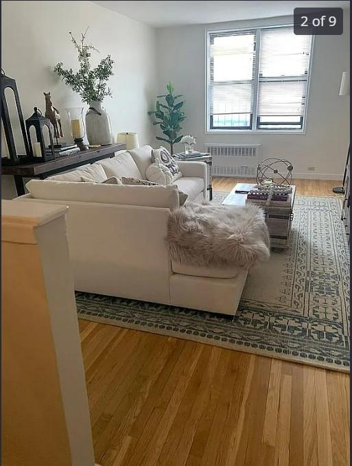 555 Bronx River Rd Unit 5E, Yonkers, NY 10704 - living room with radiator heating unit and wood finished floors