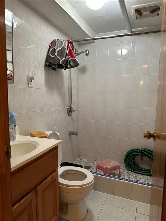 1762 64th St, Brooklyn, NY 11204 - full bath featuring tile patterned flooring, a tile shower, tile walls, and vanity