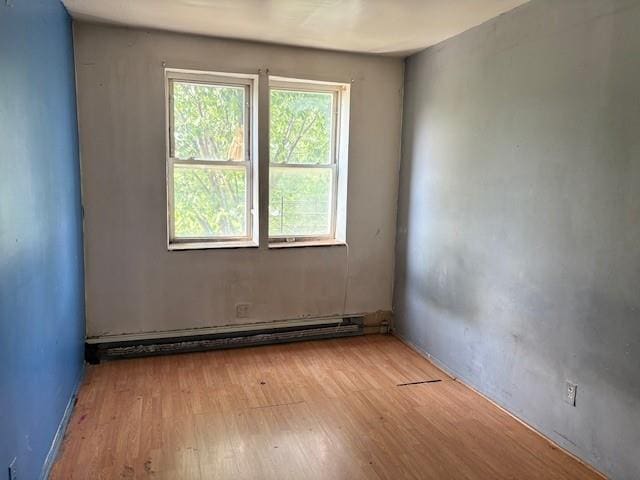 894 New Lots Ave, Brooklyn, NY 11208 - unfurnished room with wood finished floors and a baseboard radiator