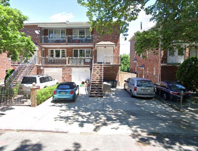 1247 E 69th St, Brooklyn, NY 11234 - townhome / multi-family property featuring stairway, brick siding, and concrete driveway