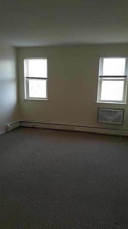 1247 E 69th St, Brooklyn, NY 11234 - empty room featuring carpet flooring and baseboard heating