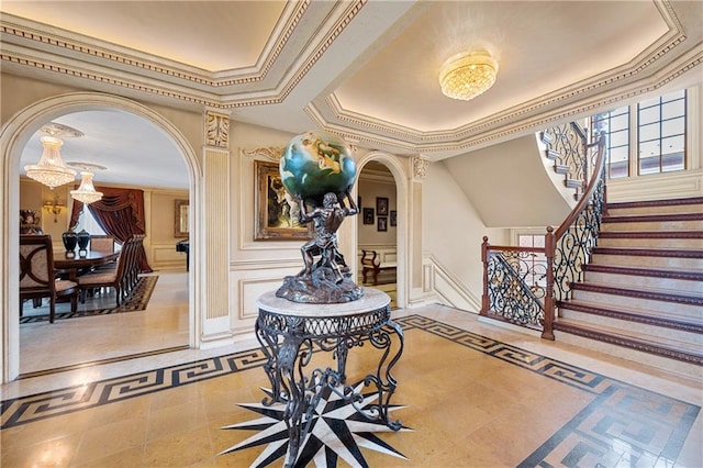 8524 Ridge Blvd, Brooklyn, NY 11209 - entrance foyer featuring arched walkways, inlaid floor details, a raised ceiling, a decorative wall, and a chandelier
