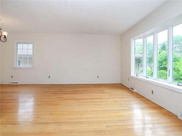 45 W Ter, Staten Island, NY 10312 - spare room with light wood-style floors and a chandelier