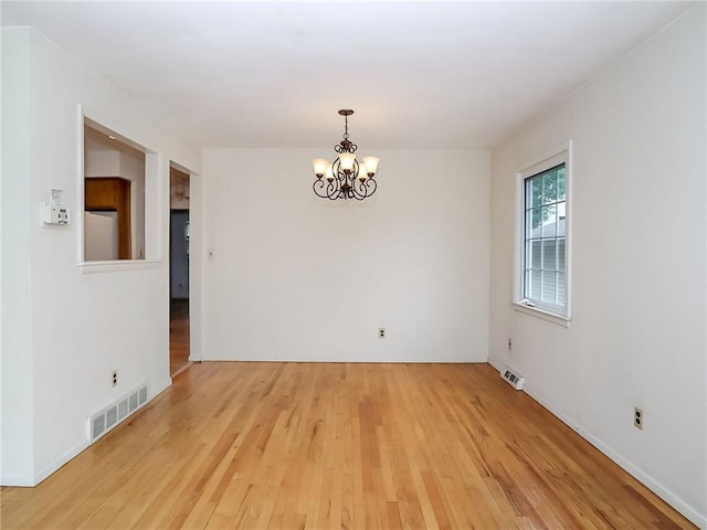 45 W Ter, Staten Island, NY 10312 - spare room featuring a chandelier and light wood-type flooring