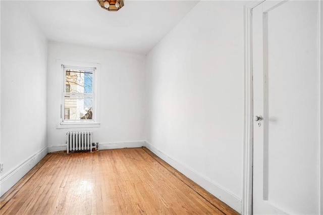 8301 4th Ave, Brooklyn, NY 11209 - spare room with radiator heating unit and light wood finished floors