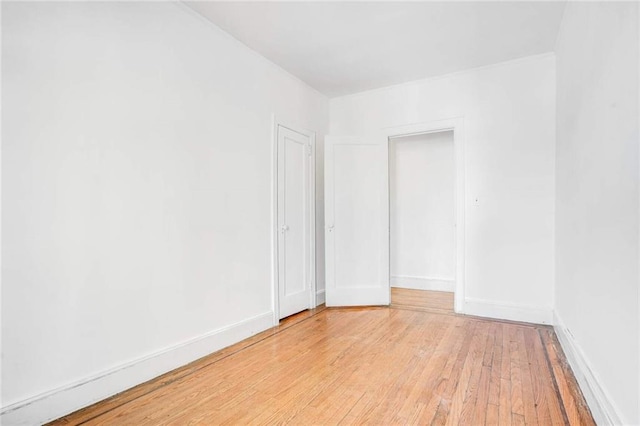 8301 4th Ave, Brooklyn, NY 11209 - unfurnished room with light wood finished floors and baseboards