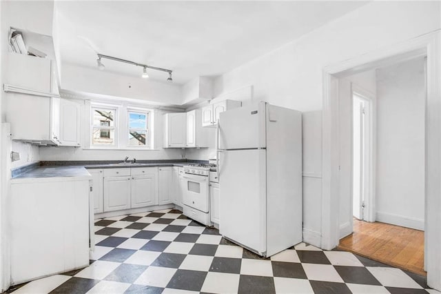 8301 4th Ave, Brooklyn, NY 11209 - kitchen with white appliances, tile patterned floors, white cabinets, dark countertops, and track lighting
