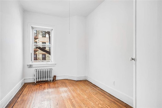 8301 4th Ave, Brooklyn, NY 11209 - empty room featuring radiator and light wood-style flooring