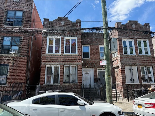 582 Williams Ave, Brooklyn, NY 11207 - view of property featuring brick siding and a fenced front yard