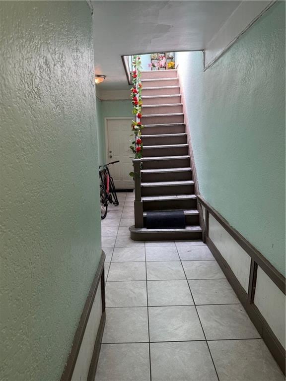 582 Williams Ave, Brooklyn, NY 11207 - stairway with a textured wall and tile patterned floors