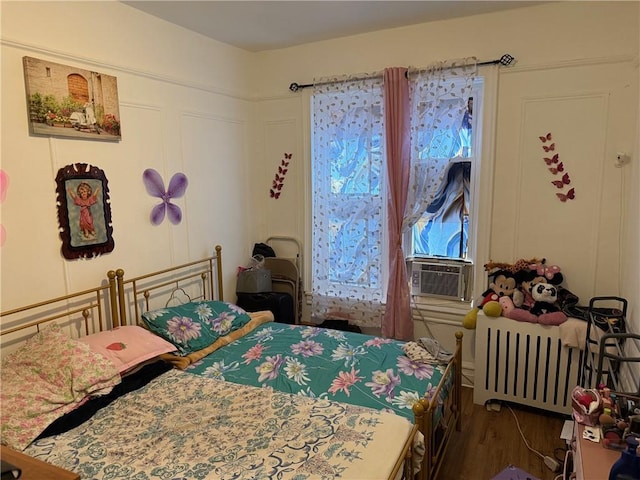 582 Williams Ave, Brooklyn, NY 11207 - bedroom featuring radiator and wood finished floors