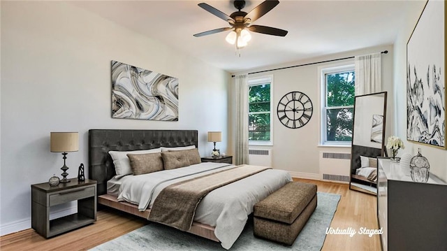 1560 E 18th St Unit 3D, Brooklyn, NY 11230 - bedroom with radiator, wood finished floors, and a ceiling fan