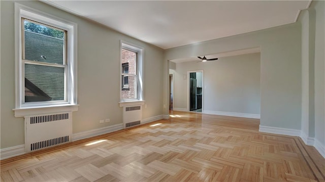 1560 E 18th St Unit 3D, Brooklyn, NY 11230 - empty room with radiator heating unit, plenty of natural light, and a ceiling fan