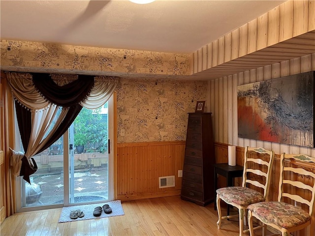 82 Seagate Ct, Staten Island, NY 10305 - living area featuring a wainscoted wall, light wood-style floors, wallpapered walls, and wooden walls