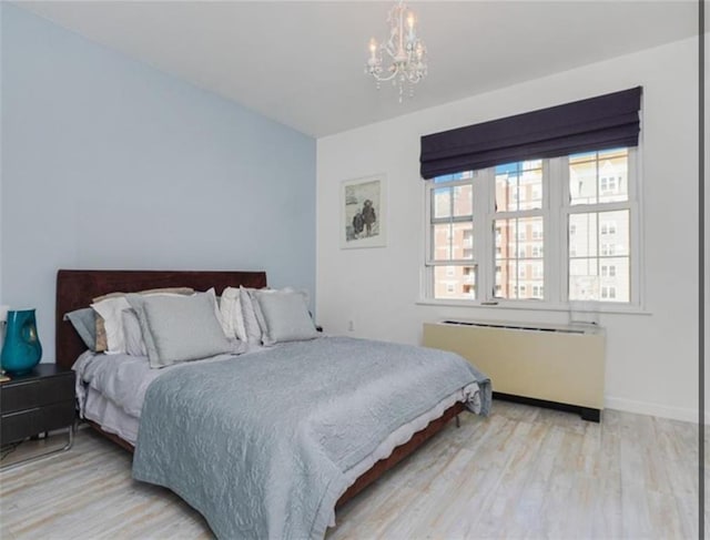 100 Oceana Dr W Unit 4J, Brooklyn, NY 11235 - bedroom with radiator, a chandelier, and wood finished floors