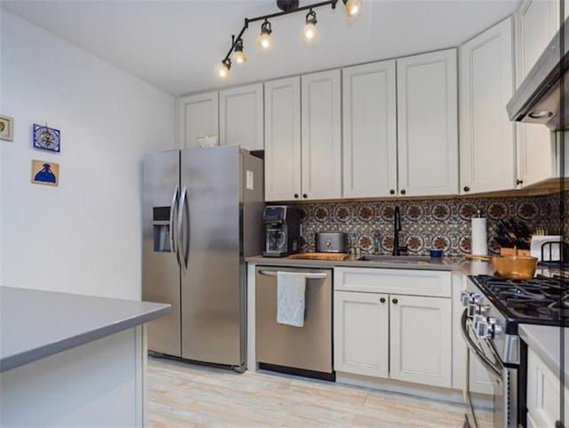 100 Oceana Dr W Unit 4J, Brooklyn, NY 11235 - kitchen with appliances with stainless steel finishes, ventilation hood, tasteful backsplash, and light wood-type flooring
