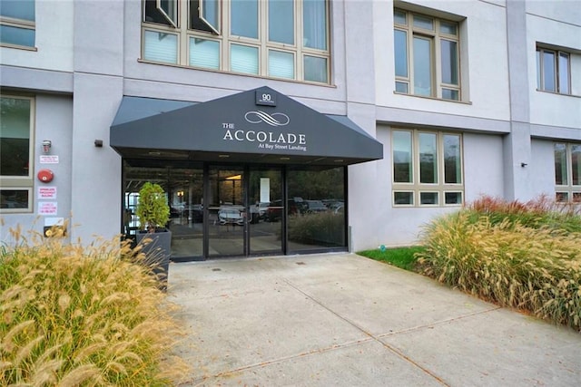 90 Bay Street Lndg Unit 4B, Staten Island, NY 10301 - property entrance with stucco siding and concrete driveway